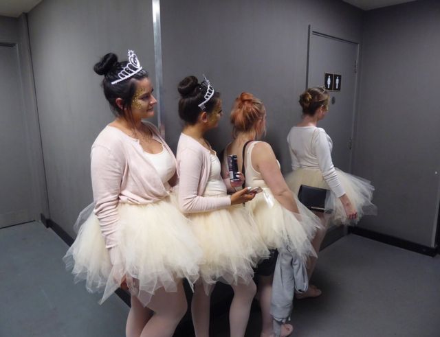 Ballerinas waiting in a queue for the loo