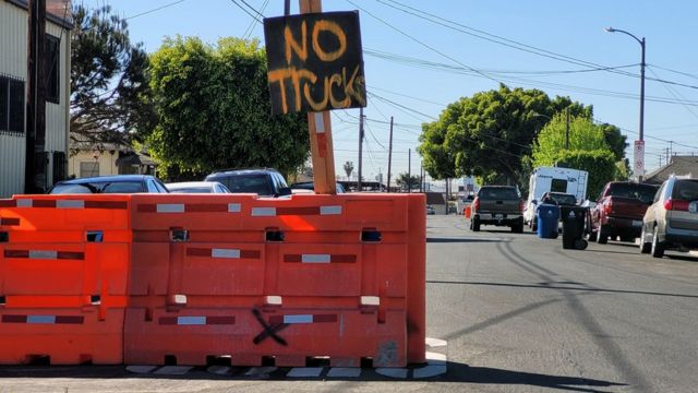 No Trucks sign next to barricades.