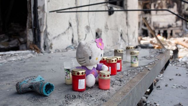 Candles and a toy in memory of the dead children in Borodyanka