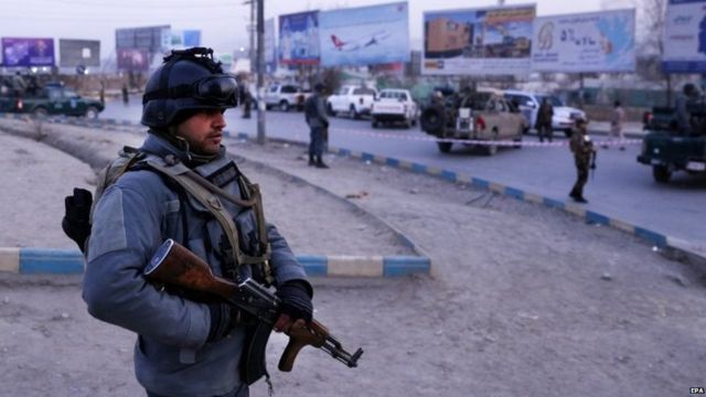 Afghan security officials stand guard at the scene of a suicide car bomb attack in Kabul