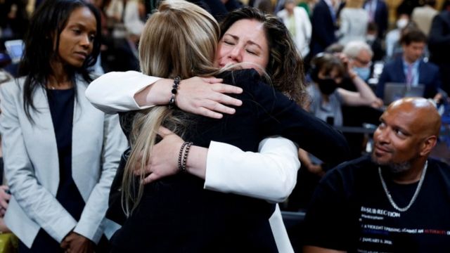 U.S. Capitol Police Officer Caroline Edwards embraces Sandra Garza, partner of Brian Sicknick next to Serena Liebengood, widow of Capitol Police officer Howie Liebengood, after her testimony during the hearing of the U.S. House Select Committee to Investigate the January 6 Attack on the United States Capitol on Capitol Hill in Washington, U.S., June 9, 2022.