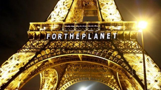 Eiffel Tower with sign reading FOR THE PLANET