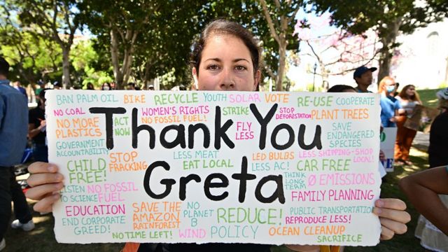 Joven con un cartel que dice: "Gracias Greta"