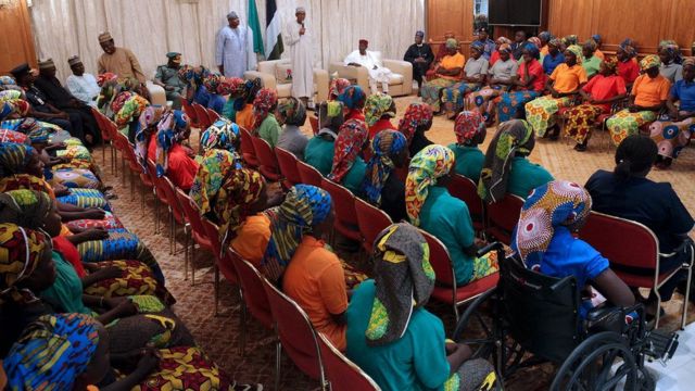 Nigeria"s President Muhammadu Buhari (L) addresses the 82 rescued Chibok girls during a reception ceremony at the Presidential Villa in Abuja, on May 7, 2017.
