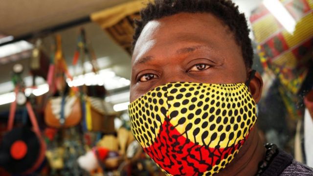Un homme portant un masque à l'intérieur d'un magasin au Cap