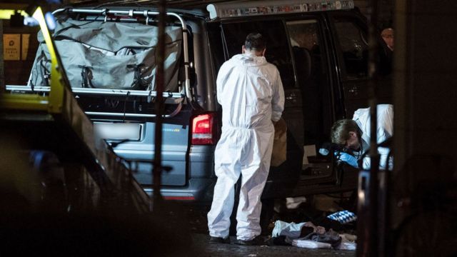 Forensics crews investigate the van used in the attack