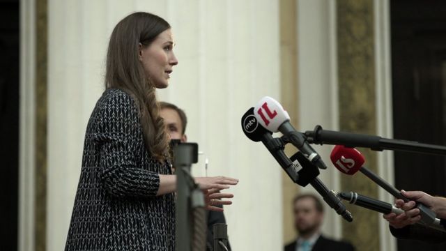 Sanna Marin speaks to journalists outside the House of Estates