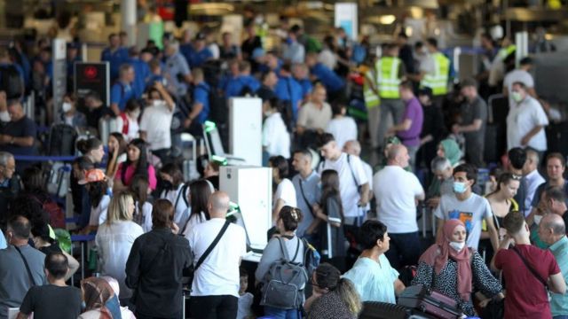 Dozens of people line up at a German airport