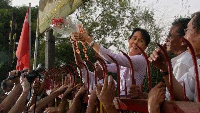 Aung San Suu Kyi greets supporters on her release from house arrest in 2010