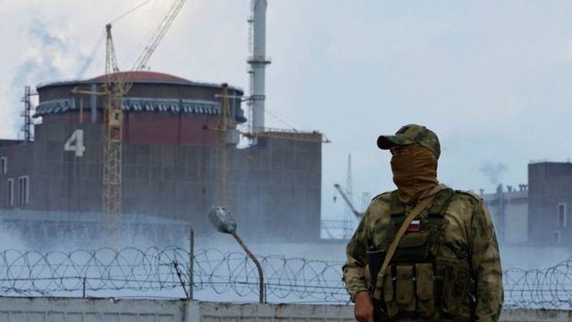 A man in front of the Zaporizhzhia nuclear plant