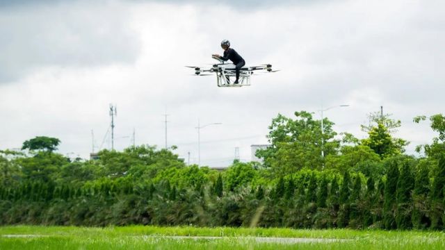 Zhao Deli rides a flying motorbike, which he built himself, during a test flight in 2019 in China