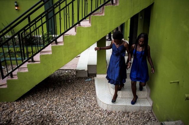Two young women are seen ahead of a welcoming ceremony for first year students on February 3, 2018 in Beni.