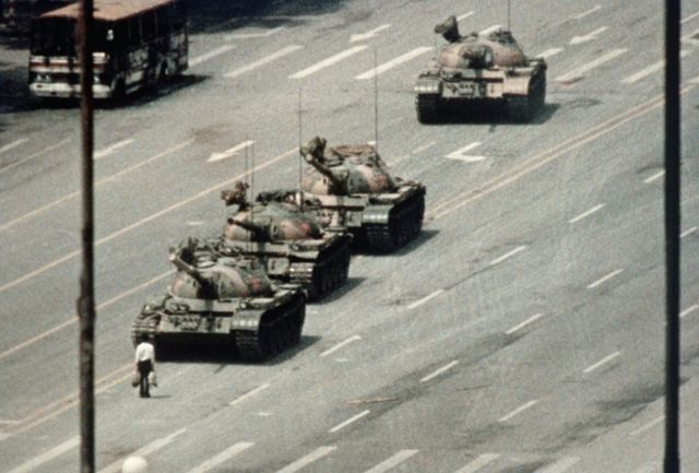 A Beijing demonstrator blocks the path of a tank convoy along the Avenue of Eternal Peace near Tiananmen Square. For weeks, people have been protesting for freedom of speech and of press from the Chinese government.