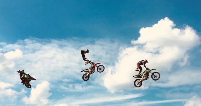 Three motorcycles in the air