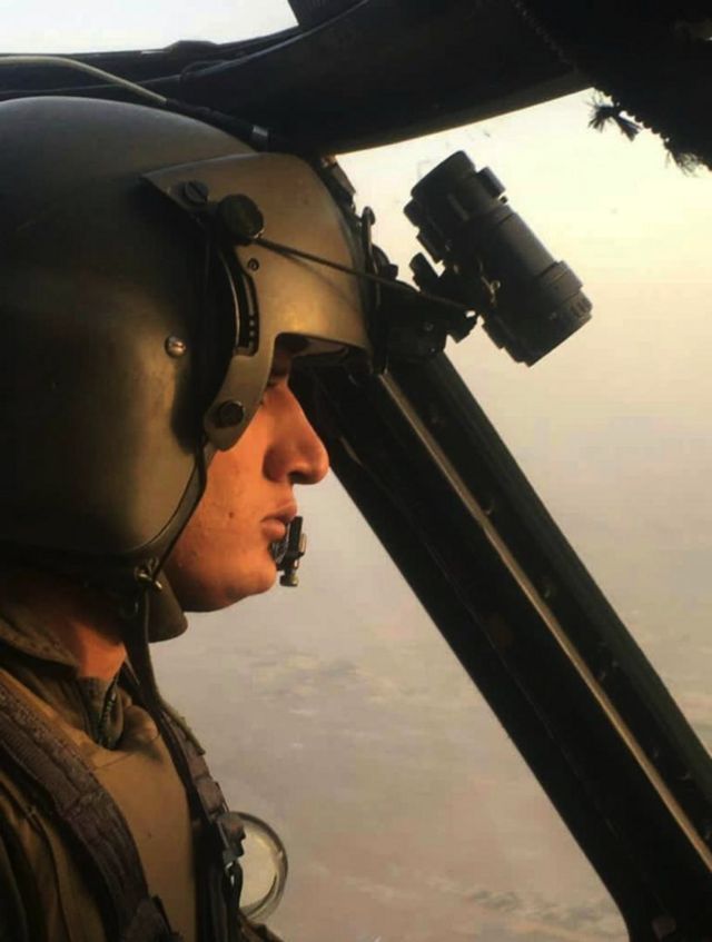 Mohammad Edris Momand. flying in the helicopter cockpit with ground visible out of the window