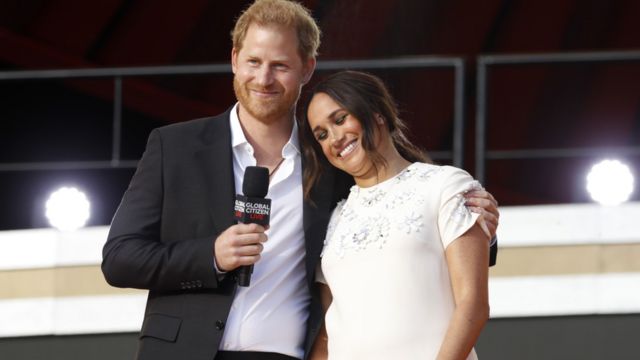 The Duke and Duchess of Sussex speak at a public event.