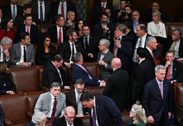 A member of the House of Representatives grabs Rep. Mike Rogers by the face after Rogers lunges at Rep. Matt Gaetz to vote him out. "currently" Instead of voting for McCarthy in the 14th ballot for Speaker of the House on January 6, 2023.