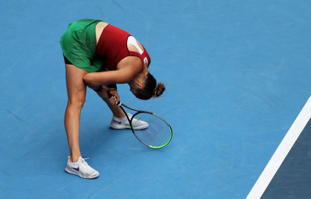 Tennis player squats, hit by heat