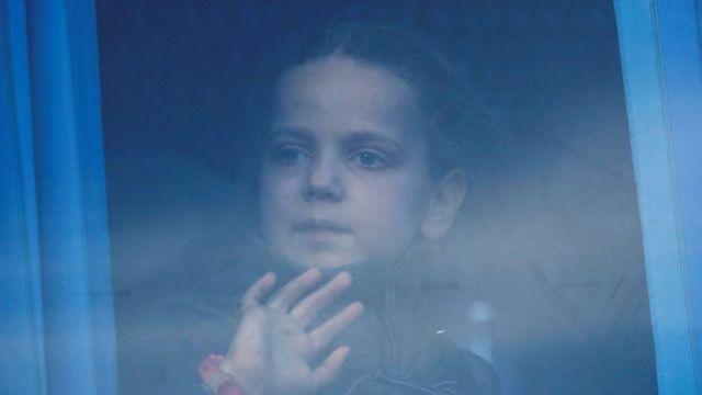 A girl looks through the bus window as civilians evacuated from Azovstal steel plant in Mariupol arrive at a temporary accommodation centre in the village of Bezimenne, during Ukraine-Russia conflict in the Donetsk Region, Ukraine May 6, 2022.