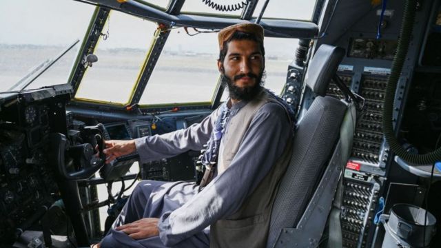 Taliban fighter in US aircraft at Kabul Airport