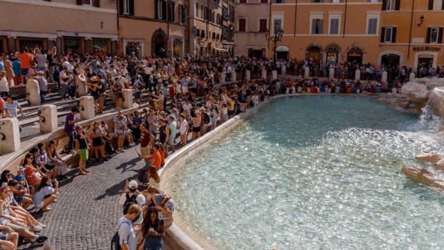 Tourists crowd Rome's Fontana Di Trevi