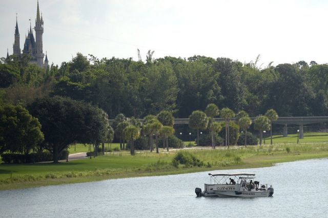 Orange County Sheriff's officers search the Seven Seas Lagoon between Walt Disney World's Magic Kingdom theme park, left, and the Grand Floridian Resort Spa, 15 June