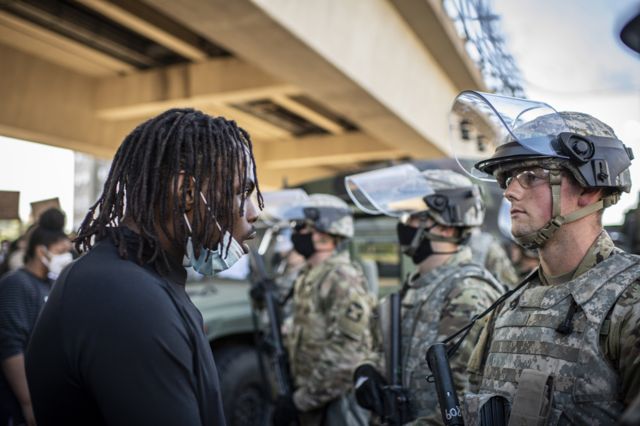 4. A demonstrator pleads with a Minnesota National guardsmen during protests resulting from the killing of an unarmed black man, George Floyd, by police.