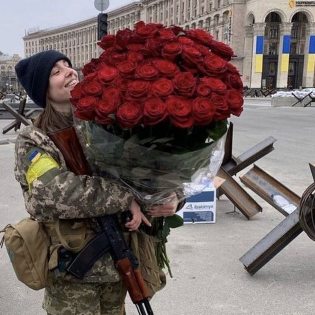 Marharyta Rivachenko holds a giant bouquet of roses.