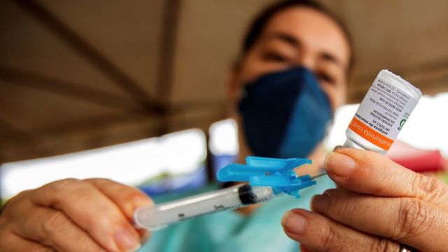 A nurse prepares a covid-19 vaccine on a vaccination drive-thru, in Brasilia, Brazil, 10 March 2021.