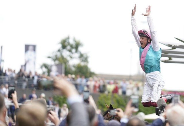 Frankie Dettori performs a trademark flying dismount as punters cheer at Ascot