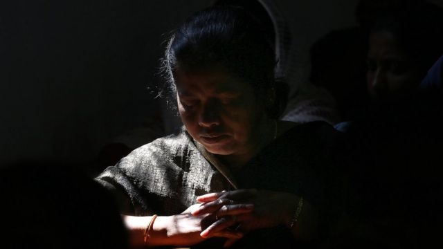 An Indian Christian woman prays at a cathedral in New Dehli