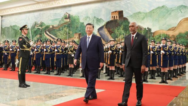 The photo taken on January 10, 2024 shows Maldives' President Mohamed Muizzu (R) and Chinese President Xi Jinping walking during a welcome ceremony at the Great Hall of the People in Beijing.