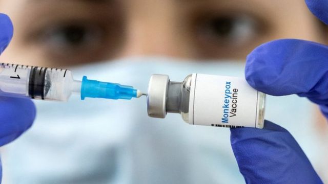 Health worker holding monkeypox vaccine