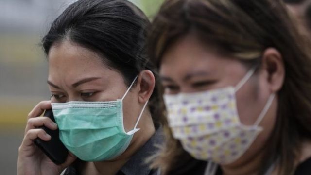 Dua orang mengenakan masker di Jakarta, di tengah kepastian soal dua kasus virus corona.