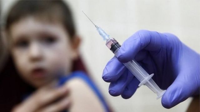 Дитина і рука зі шприцом