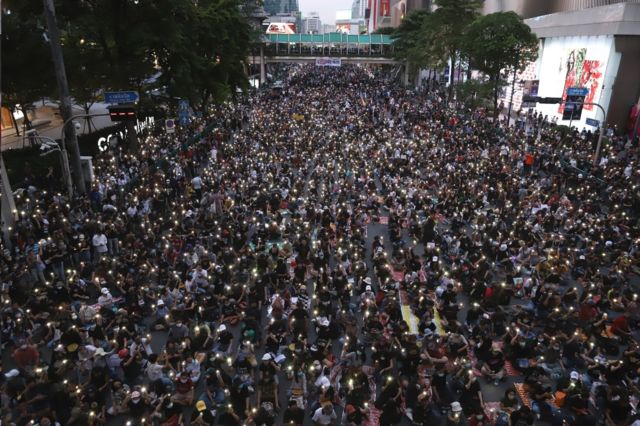 The traffic surface at the Ratchaprasong intersection is packed with crowds.