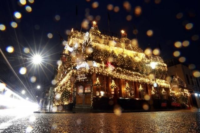 A pub is lit up with Christmas lights decorations in London, UK. Photo: 24 December 2021