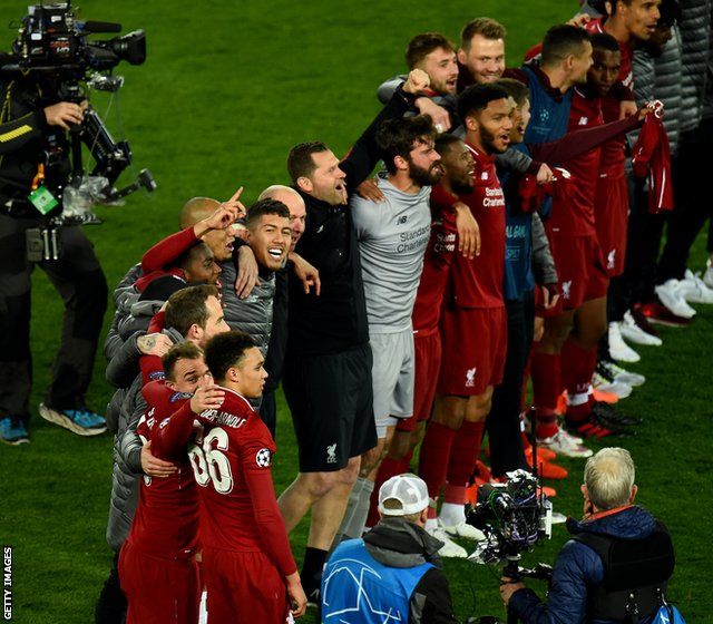 Liverpool players celebrate in front of fans