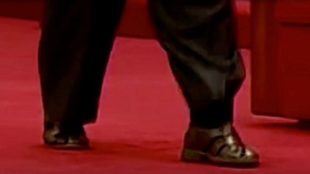 North Korean leader Kim Jong-un wears sandals and socks at a military exhibition