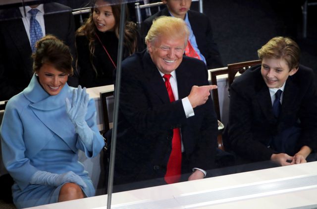 President Donald Trump, First Lady Melania Trump and Barron Trump watch the inaugural parade