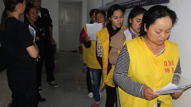 An image from inside the rarely seen confines of a detention centre, which appears to show Uyghurs being "re-educated"