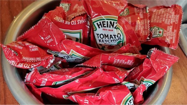 Close-up of container of Heinz brand ketchup packets in restaurant setting, Lafayette, California, November 6, 2020.