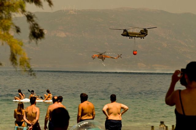 Helicopters bring water to put out the fires