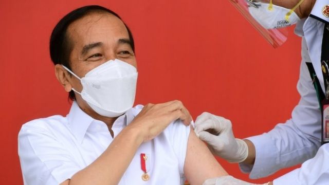 President Joko Widodo reacts after receiving a shot of COVID-19 vaccine at the Merdeka Palace in Jakarta, Indonesia, January 13, 2021.
