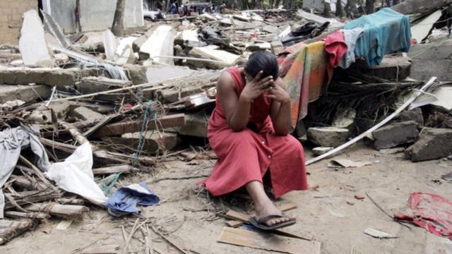 A woman cries as she sits in the rubble of her house in the village of Kalamulla , 40 km from Colombo, southwestern Sri Lanka, 02 January 2005. Officials estimate nearly 30,000 people were killed in Sri Lanka in last Sunday's tsunami strike, the worst natural disaster in living memory to hit the island nation of 19 million people
