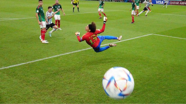Argentina's Enzo Fernandez curls in past a diving Mexico goalkeeper Guillermo Ochoa