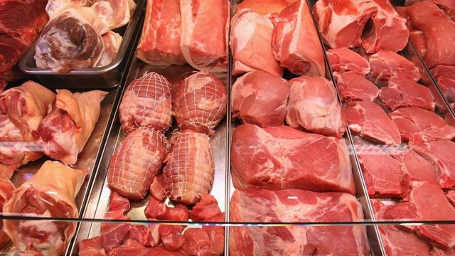 Puesto de carnicería con piezas de carne roja.