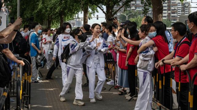 Teachers greet students as they arrive for the first day of the National College Entrance Exam, or Gaokao, at the Renmin University Affiliated High School, one of the countrys most prestigious schools, on June 7, 2023 in Beijing,