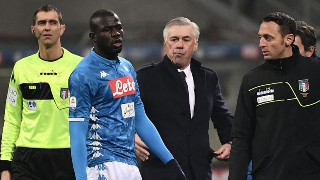 Napoli's Senegalese defender Kalidou Koulibaly (Napoli's) exits the pitch after receiving a red card as Napoli coach Carlo Ancelotti (C) looks on
