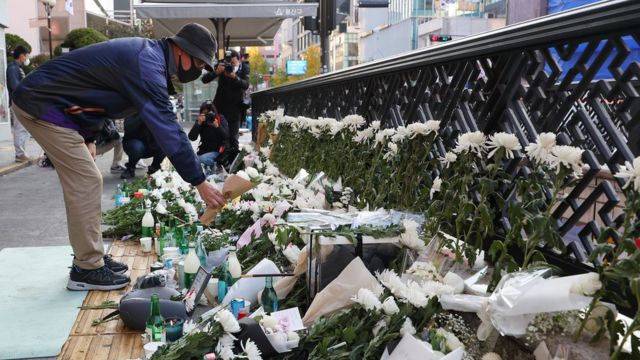 South Koreans visit flowers in memory of the victims near the stampede site.